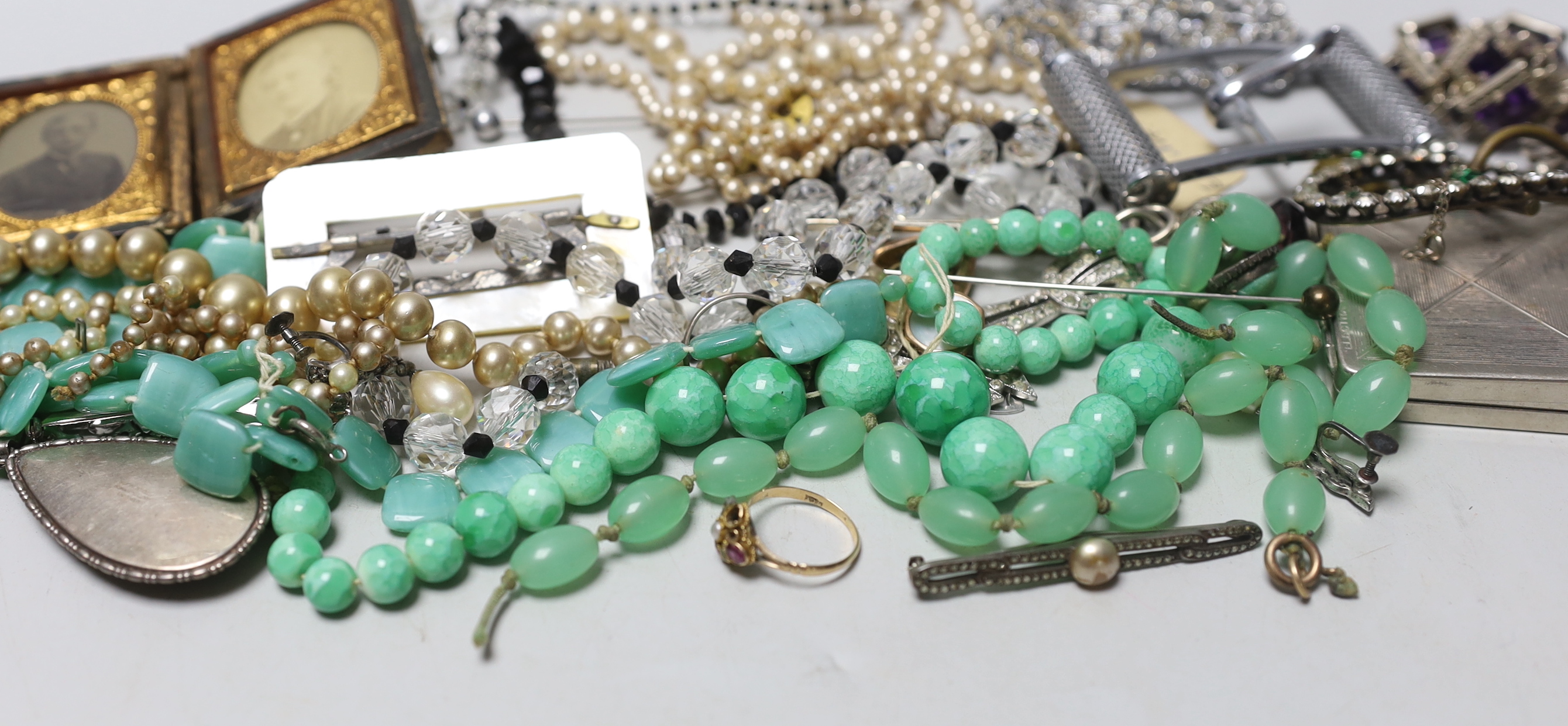An early 20th century 9ct and gem set 'Suffragette' ring (stones missing) and a group of costume jewellery.
